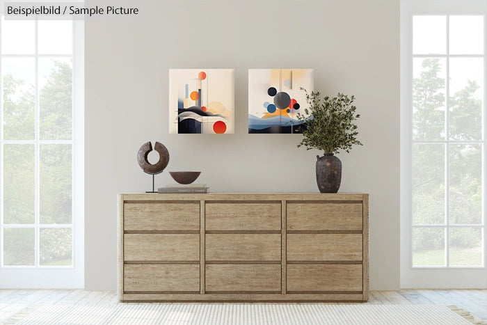 Modern living room with abstract paintings, wooden dresser, and decorative vases near large windows.