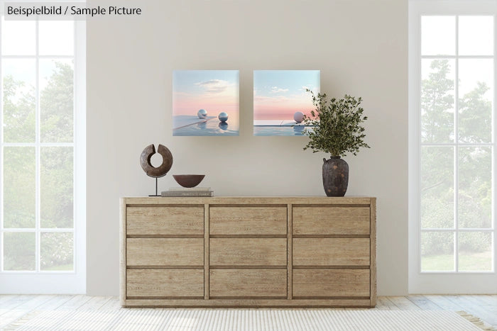 Minimalist decor with sideboard, abstract art, sculpture, and potted plant in a sunlit room with large windows.