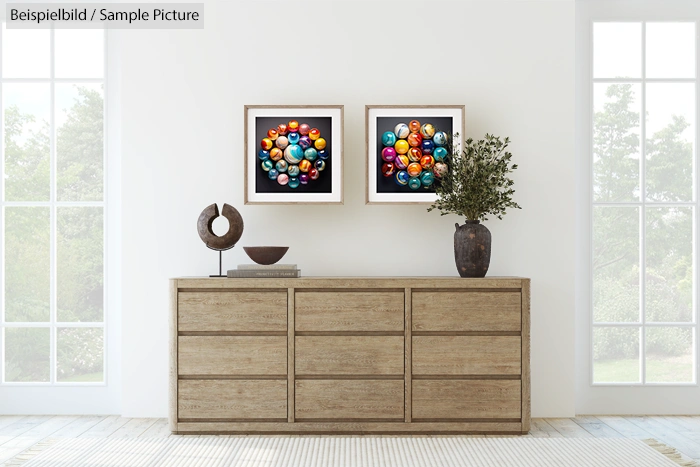 Modern living room with wooden dresser, abstract art, and plant.