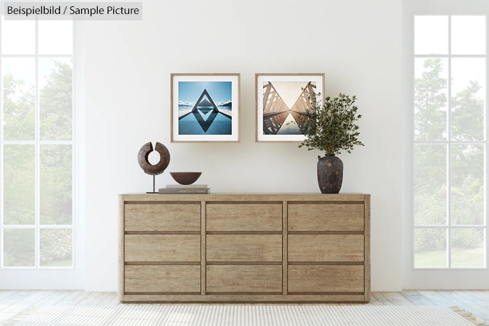 Modern living room with wooden sideboard, abstract art, plant, and sculpture on a light carpeted floor.