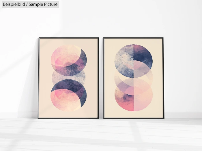 Two abstract geometric art prints with overlapping circles in pink, purple, and beige tones, framed and displayed side by side.