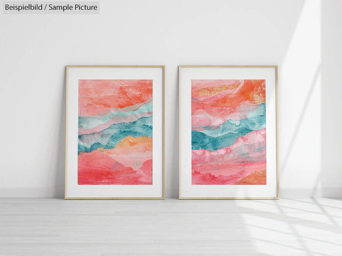 Two framed abstract paintings with coral, teal, and pink hues on a white wall.