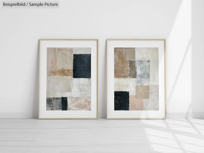 Two framed abstract paintings with geometric shapes in neutral tones, displayed on a light floor against a white wall.