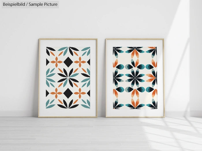 Two framed geometric art prints with teal, orange, and black patterns on a white wall.