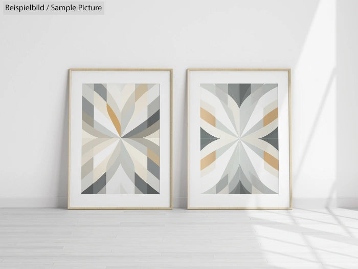 Two framed abstract geometric artworks on a light gray wall with a wooden floor.