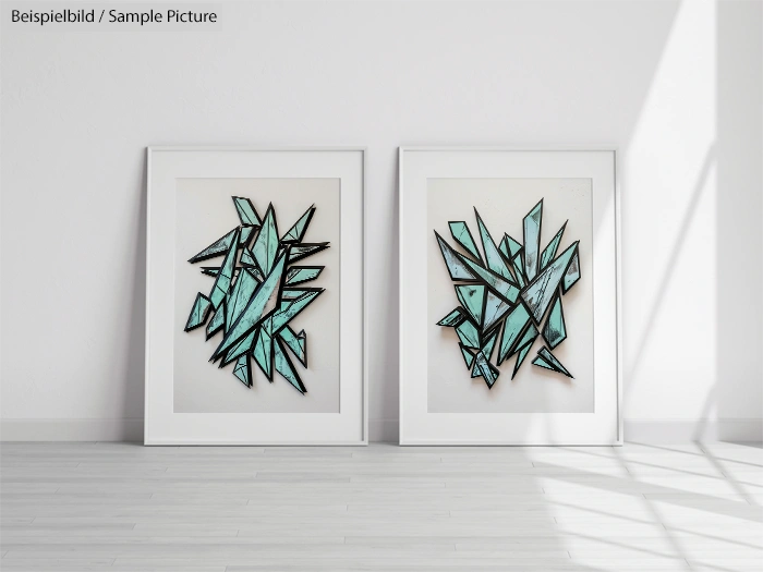 Two framed abstract art pieces with geometric blue shapes on a white wall in a well-lit room.