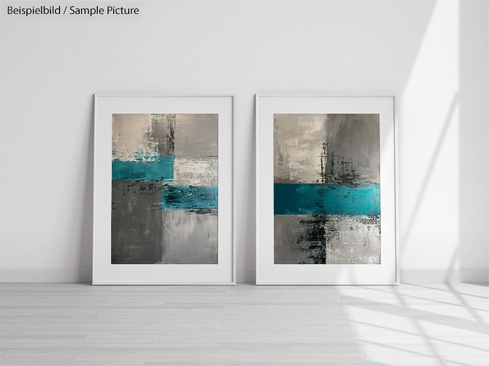 Two abstract paintings with blue and gray blocks, framed and placed on a light wooden floor in a bright room.