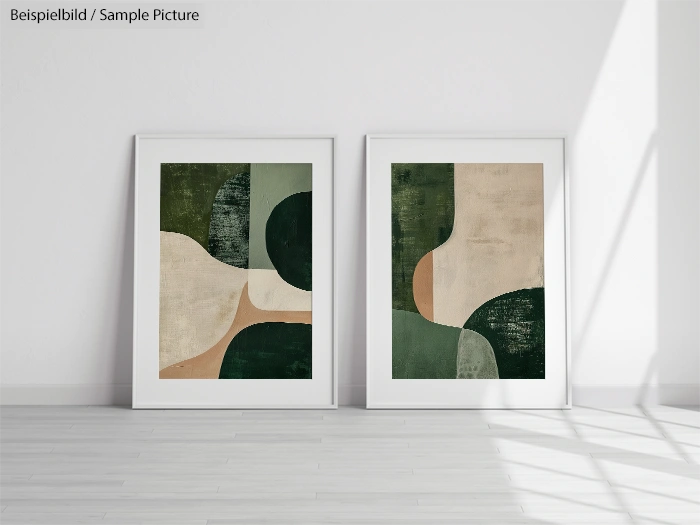 Two modern abstract paintings with green, beige, and dark accents, displayed in white frames on a wooden floor.