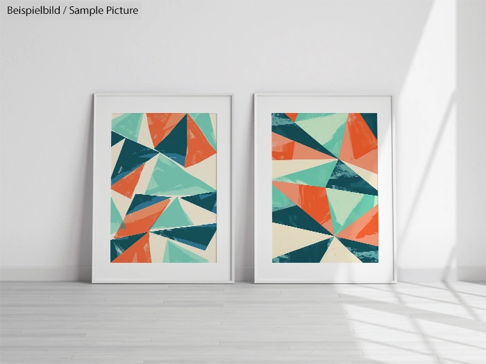 Two framed abstract geometric paintings on a white wall, featuring bold triangles in teal, orange, and cream tones.