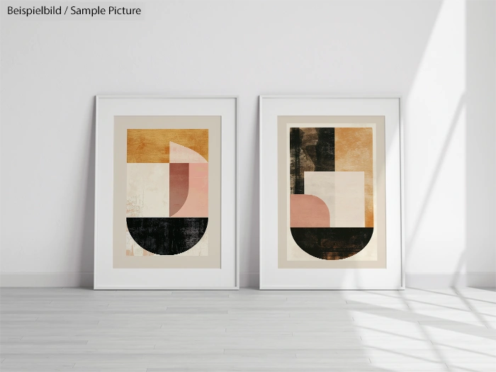 Two framed abstract art prints with geometric shapes in pastel colors, leaning against a white wall on a light wooden floor.