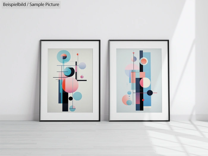 Two framed abstract geometric artworks with circles and lines in pastel colors on a white wall.