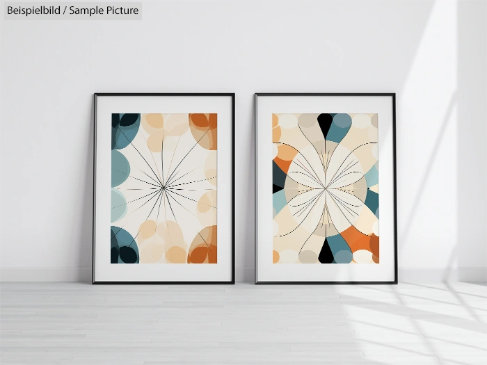 Two framed abstract artworks with geometric patterns on a white wall in a minimalist room with wooden flooring.