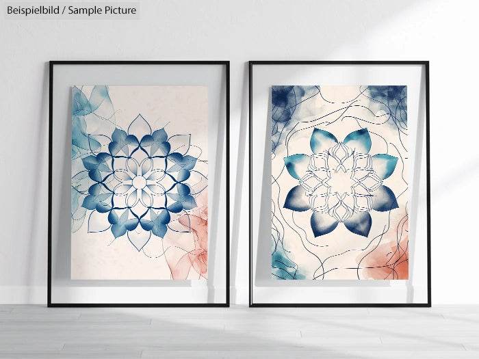 Two framed floral mandala artworks in blue and red hues, displayed on a light wooden floor.