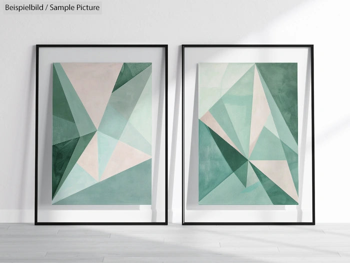 Two geometric paintings in shades of green and beige framed and placed on a hardwood floor against a white wall.