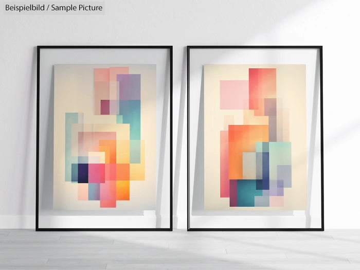 Two framed abstract artworks with colorful geometric shapes leaning against a white wall.