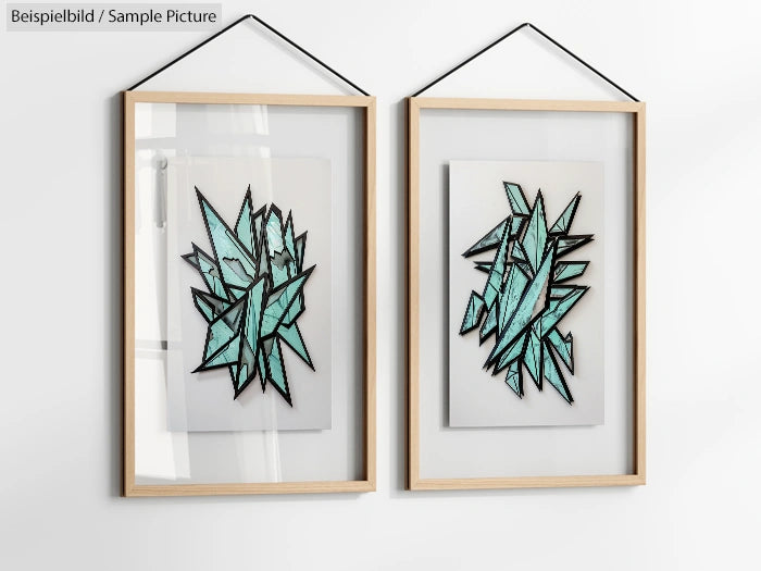 Two abstract geometric artworks with black outlines and teal fill, framed and hung on a white wall.