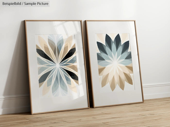 Two framed abstract floral prints with beige, blue, and gray leaf patterns on a wooden floor against a white wall.