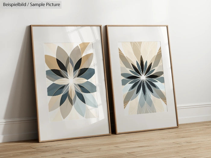 Two framed geometric floral art prints with blue, beige, and gray tones leaning against a white wall on wooden floor.