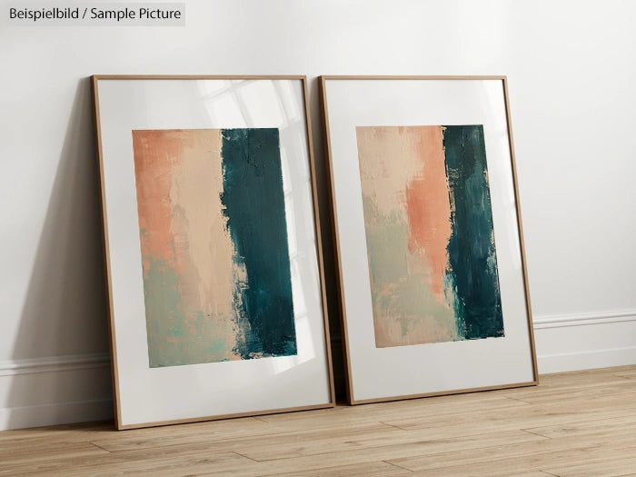 Two abstract paintings with vertical teal and peach color blocks, framed and leaning against a light wall.