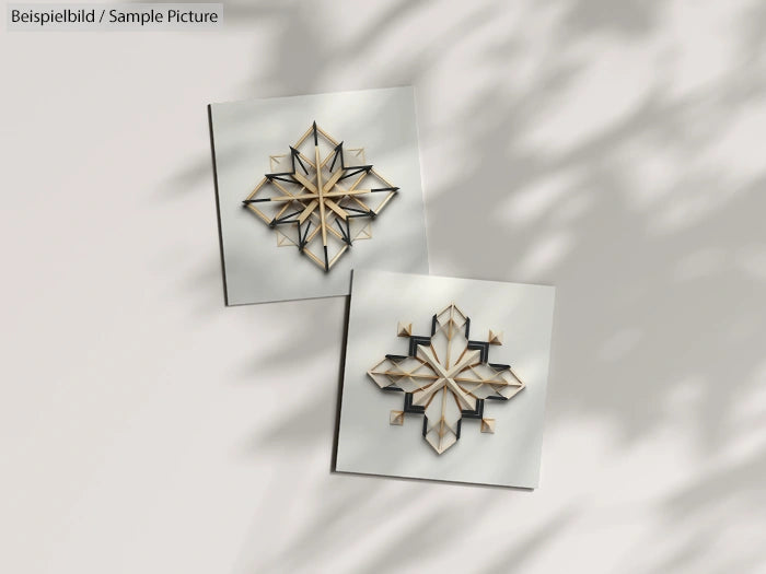 Two geometric star-shaped designs on square glass tiles, with shadow patterns in the background.