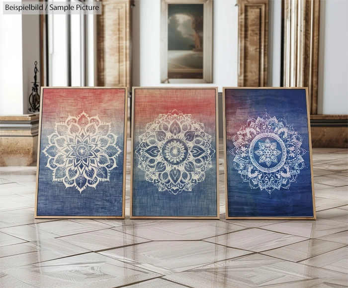 Three framed mandala art pieces in varying shades of red and blue, displayed indoors with wooden trim.