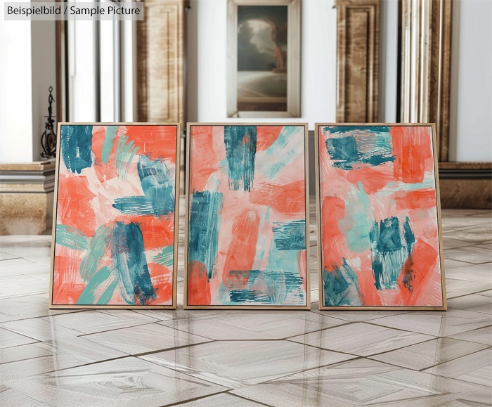 Three abstract paintings with vibrant orange, teal, and white brushstrokes displayed in elegant interior.