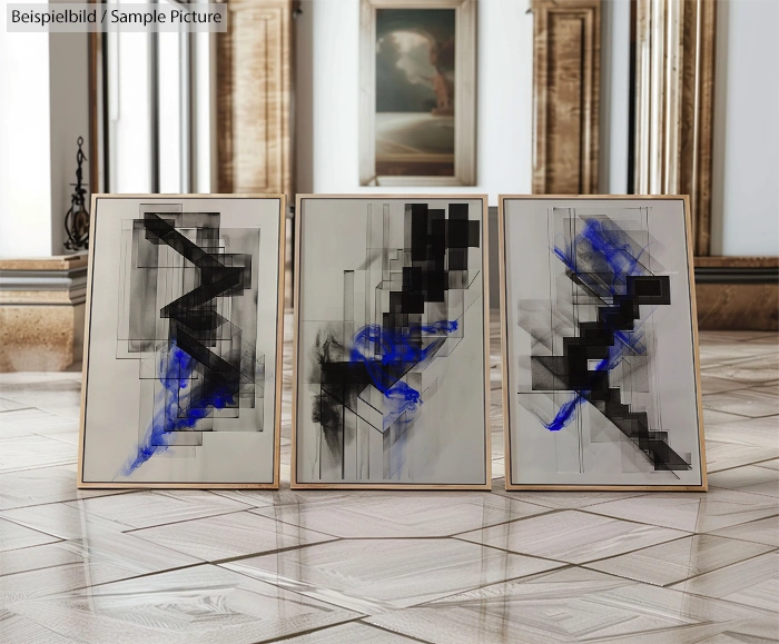 Three abstract paintings on floor with blue and black geometric designs in ornate room.