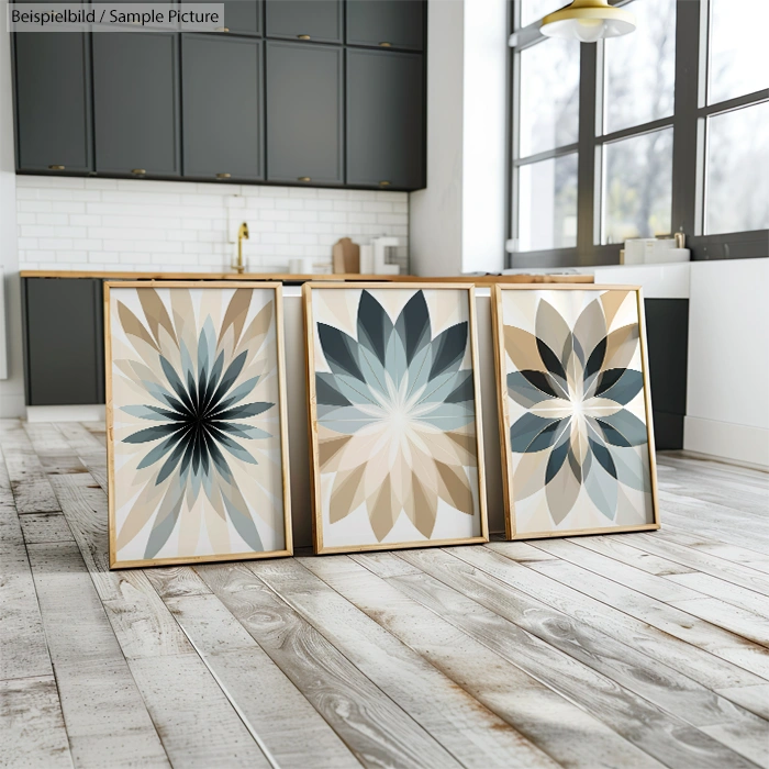 Three large geometric floral art prints in a modern kitchen setting with wooden floors and dark cabinets.