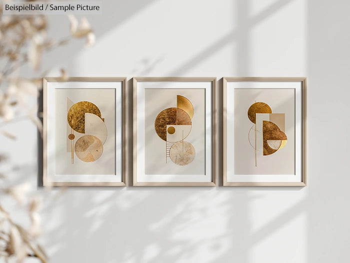 Set of three framed abstract geometric artworks with golden circles and rectangles on a light wall.