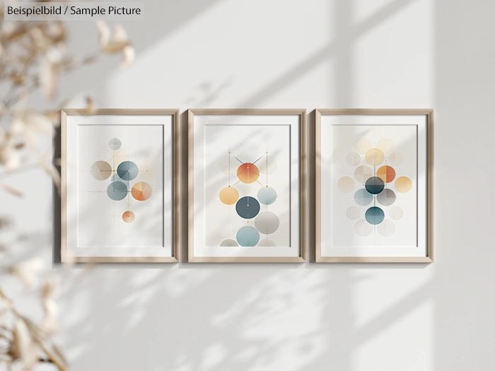 Three framed abstract art prints with overlapping colorful circles, displayed on a light-colored wall.