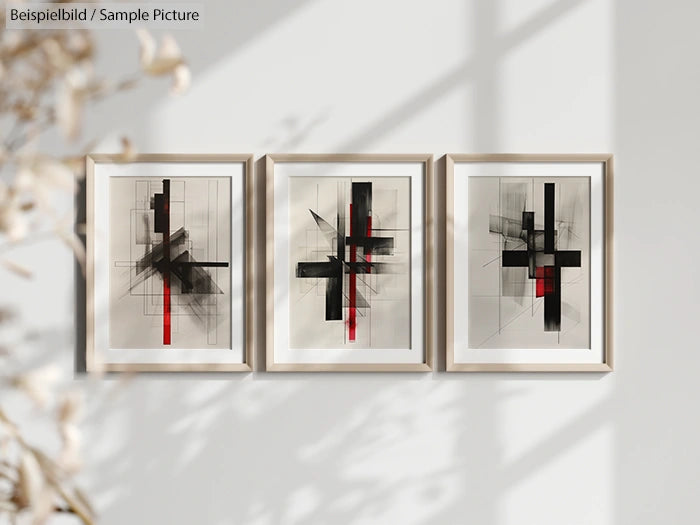 Abstract geometric art prints in a row with black and red lines, framed and hung on a light-colored wall.