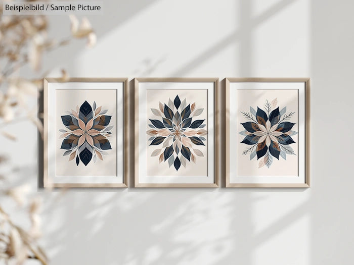 Three framed botanical leaf art prints on a wall with soft lighting and shadows.