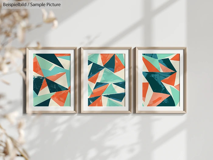 Three framed abstract geometric paintings in teal, orange, and cream colors, displayed on a wall with a plant shadow.