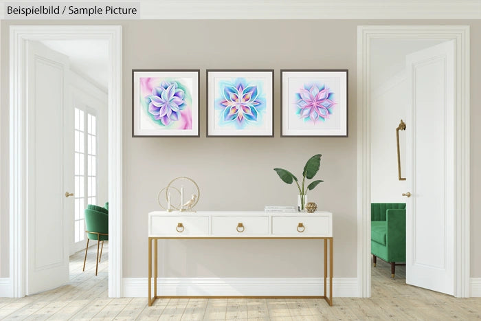 Modern living room with plant and framed abstract art on beige wall above white console table.