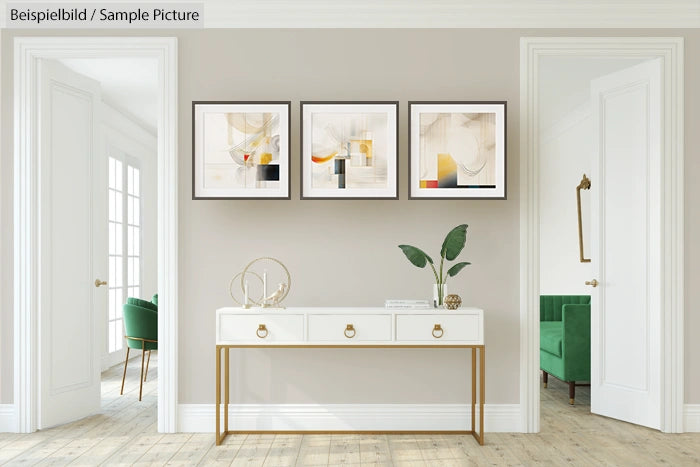 Minimalist living room with elegant console table, abstract art, and green chairs by large windows.