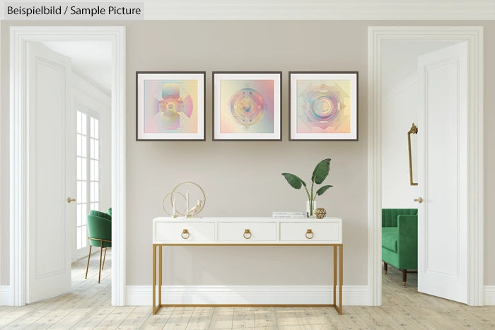 Minimalist hallway with white console table, potted plant, and three abstract artworks on a beige wall.