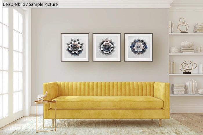 Modern living room with yellow sofa, three abstract art pieces on wall, and minimalist decor on shelves.