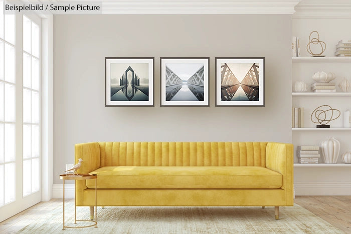 Modern living room with yellow sofa and three framed art prints on wall.