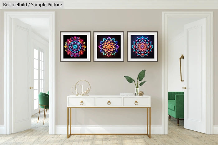 Room with white console table, three colorful mandala artworks, and green chairs by the windows.