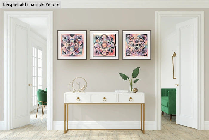 Minimalist room with white console table, decorative items, and three abstract floral artworks on pale wall.