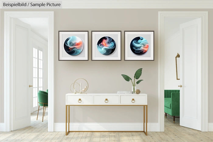 Modern living room with three abstract paintings above a white console table, featuring plant decor and books.