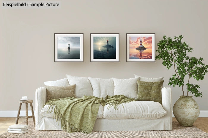 Cozy living room with white sofa, green pillows, and three lighthouse artworks on the wall.