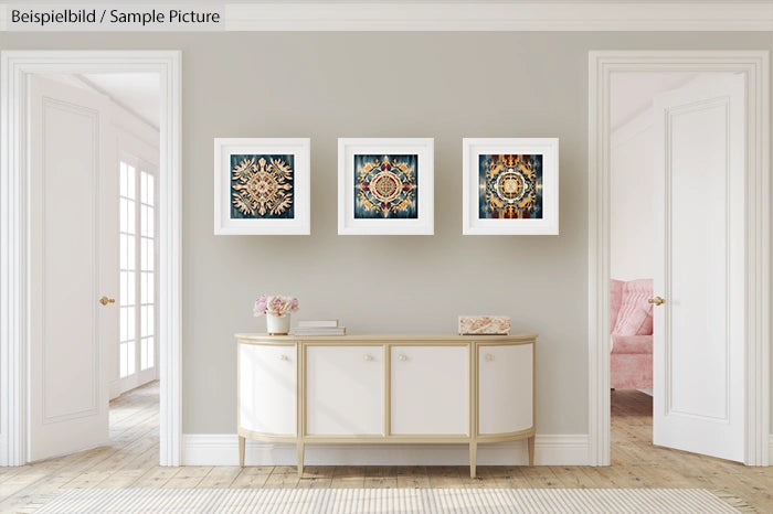 Elegant hallway with three abstract art pieces and a modern white console table.