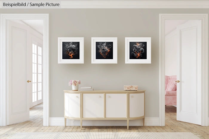 Modern hallway with white console table and three abstract art frames on the wall.