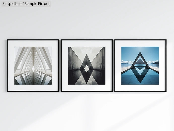 Three framed geometric art prints on a white wall, featuring triangular and diamond shapes in monochrome and blue tones.