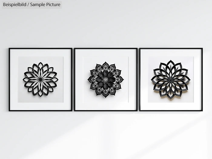 Three framed black floral patterns on white wall, minimalistic design.