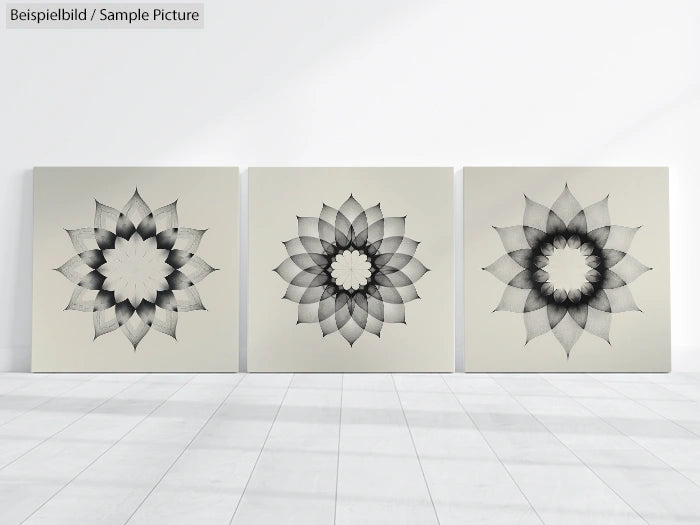 Three canvases with geometric black and white floral designs on a minimalist white background.