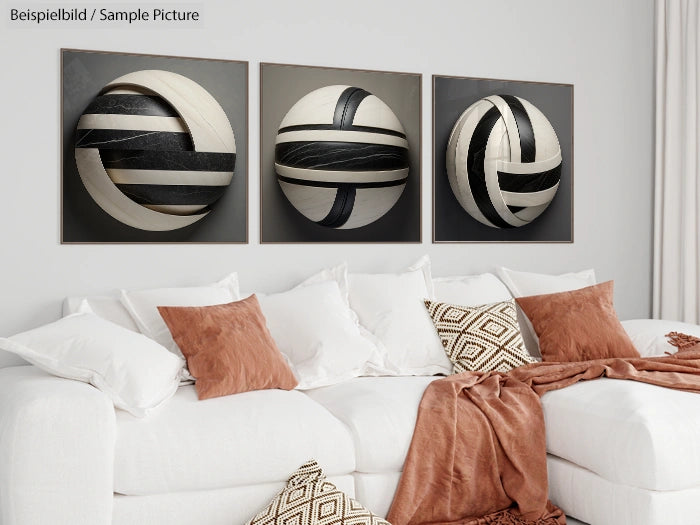 Modern living room with white sofa, brown pillows, and abstract black and white art pieces on the wall.