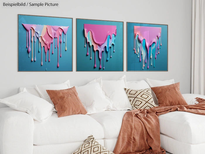 Modern living room with a white sofa, brown cushions, and abstract dripping paint artworks on the wall.