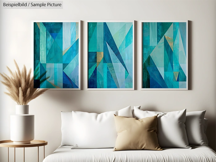 Modern living room with beige couch, geometric blue triptych art, and dried pampas grass in a white vase.